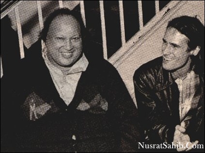 Pakistani musician Nusrat Fateh Ali Khan (1948 - 1997) (left) shares a laugh with American musician Jeff Buckley (1966 - 1997) backstage after Khans World Music Institute concert at Town Hall, New York, New York, October 7. 1995